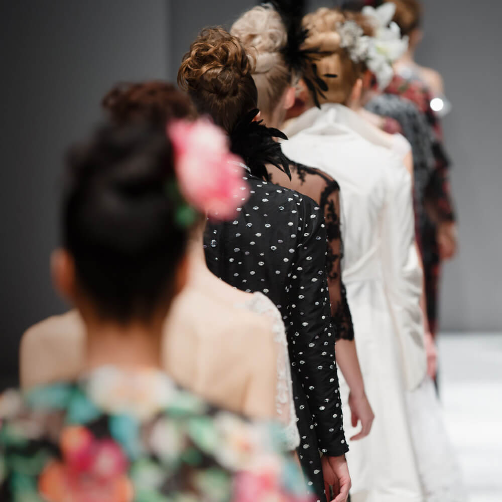 A diverse group of women confidently walking down a runway